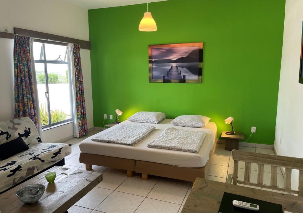 uarto com cama de casal, sofá e mesinha em resorts em Curaçao
